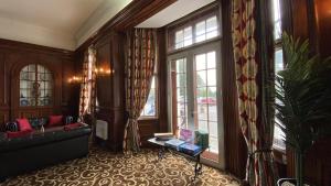 a living room with a couch and a large window at Russ Hill Hotel in Charlwood +21 photos
