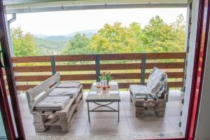 a patio with two chairs and a table on a balcony at Quinta da Quinta in Vieira do Minho