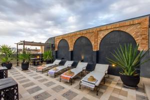a group of chairs sitting on a patio at Riad Dar El Masa in Marrakesh
