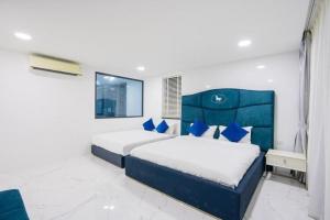 two beds in a bedroom with blue and white at My Havana, pool villa in Ban Nong Pru +7 photos