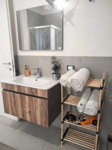 a bathroom with a sink and a mirror and towels at Milleventi in Marsala +33 photos