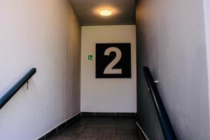 a hallway with a number sign on a wall at Zimbali lakes boulevard edge 214 in Ballito