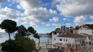 a view of the ocean and a white building at Ca sa Madona Hostal in Paguera