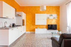 a kitchen with white cabinets and a table at Casa Oro -Pula Terrace and Wifi near downtown in Pula