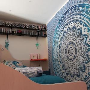 a bedroom with a wall with a large mural at IL FARO Comfort a 500 m dal mare in Casa Borgorosso