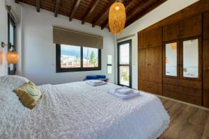 a bedroom with a large white bed and windows at Villa Nomi in Peyia +48 photos