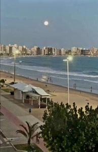 a view of a beach with a city and the ocean at Kitnet, piso superior, Praia do Morro a 300mtrs in Guarapari