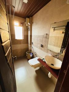 a bathroom with a sink and a toilet at Tipsy Spring Resort in Nagaon +29 photos