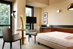 Postel nebo postele na pokoji v ubytování UNA HOTELS Cusani Milano + 37 fotografií