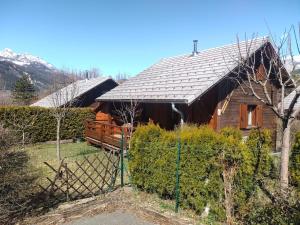 a house with a fence in front of it at CHALET MONTAGNE CLASSÉ 3 ETOILES ALPES QUEYRAs in Guillestre +5 photos