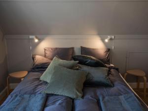 a bed with pillows on it in a room at Brakilde B&B in Stege