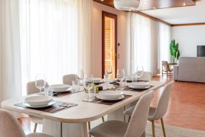a dining room with a table and chairs at Exclusive Villa with Lake view-Private SPA in Galbiate