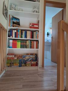 a book shelf filled with books in a hallway at Schwalbenweg in Zingst