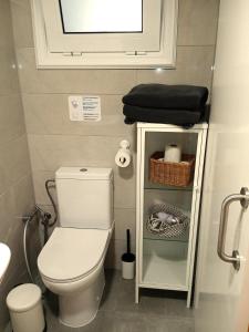 a small bathroom with a toilet and a sink at Casa con jardin para familias y grupos in Tegueste +27 photos