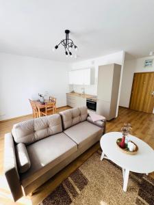 a living room with a couch and a table at Biały Żagiel in Władysławowo