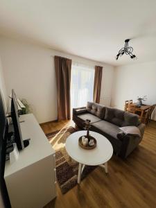 a living room with a couch and a table at Biały Żagiel in Władysławowo