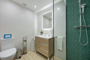 a bathroom with a shower and a toilet and a sink at Casa Azul in Portimão +15 photos