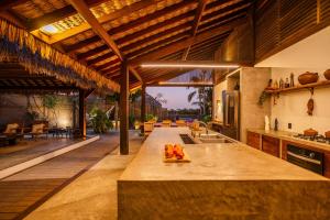 an open kitchen with a large island in a house at VILLA COLIBRI Guriú in Guriú +56 photos