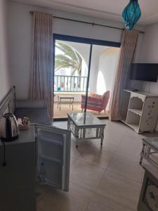 a living room with a view of a patio at villa izabelles in Djerba