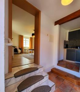 a living room with two stools in a room at Ferienwohnung Hof Schacht in Penkow