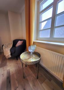 a room with a table and a chair and a window at Ferienwohnung Hof Schacht in Penkow