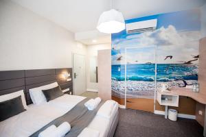 Postel nebo postele na pokoji v ubytování Hotel Gdynia Boutique + 37 fotografií