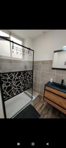 a bathroom with a sink and a mirror at Élégant studio avec jacuzzi in Saint-Paul-de-Fenouillet
