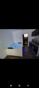 a kitchen with a tub in the middle of a room at Élégant studio avec jacuzzi in Saint-Paul-de-Fenouillet