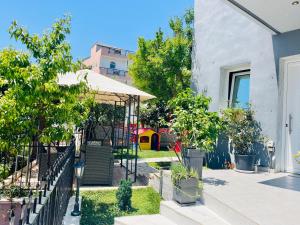 a garden with a gazebo and a playground at eliTe deluxe 4 skyview in Kavála