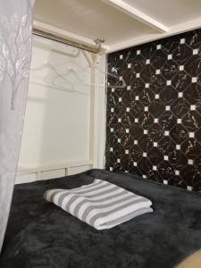 a bedroom with a bed with a towel on it at 1919hostel in Patong Beach +18 photos