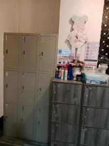 a row of lockers in a room with a wall at 1919hostel in Patong Beach