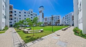 a park in the middle of a city with buildings at Homely Hideaway Buxton Point Mombasa in Mombasa