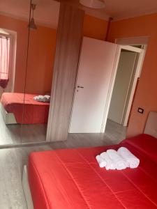 a red bedroom with two beds and a mirror at Sophie`s Home in Gallese