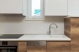 a kitchen with a sink and a window at Villa ARIJANA 2 in Slatine +81 photos