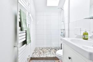 a white bathroom with a toilet and a sink at L'évasion, terrasse parking in Zillisheim