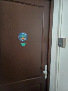 a wooden door with a sign on it at Honey room city center in Papeete