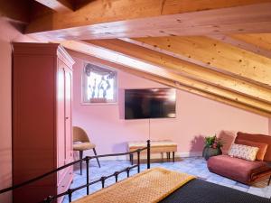 a living room with wooden ceilings and a tv at Ca' Martini Apartments in Peschiera del Garda