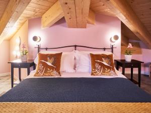 a bedroom with a large bed with two tables at Ca' Martini Apartments in Peschiera del Garda