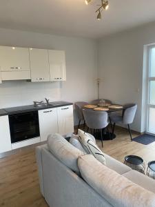 a living room with a couch and a kitchen and a table at InContri in Liège