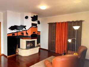 a living room with a fireplace and a couch at Apartamento Pestana in Arco da Calheta