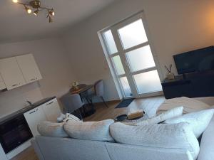 a living room with a white couch and a window at InContri in Liège