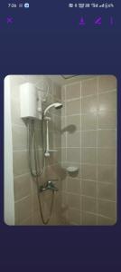 a shower in a bathroom with a shower head at Xian's place Budget Friendly Condo in Manila