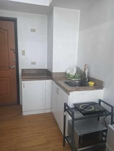 a small kitchen with a sink and a counter at Xian's place Budget Friendly Condo in Manila