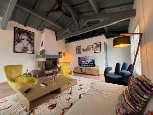 a living room with a couch and chairs and a fireplace at Maison roof-top plage & village 5 min à pied in Banyuls-sur-Mer
