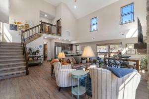 a living room with a staircase and a living room at Cloverleaf Cottage in Hollister