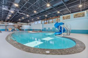 a large swimming pool with a blue water slide at Cloverleaf Cottage in Hollister