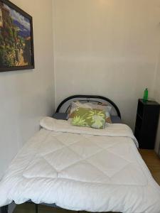 a bed with white sheets and pillows in a room at Xian's place Budget Friendly Condo in Manila