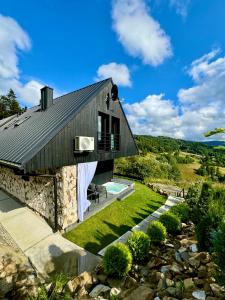 a house with a swimming pool and a yard at Bacówki Resort in Ochotnica Górna