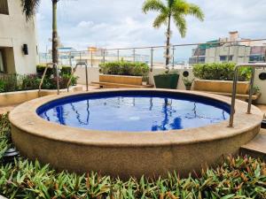 a large pool of water in a garden with palm trees at Newly Furnished Condominium in the Heart of Quezon City near Top Philippine Hospitals in Manila