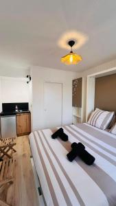 a bedroom with a large bed with two towels on it at La Cachette in La Grande-Motte